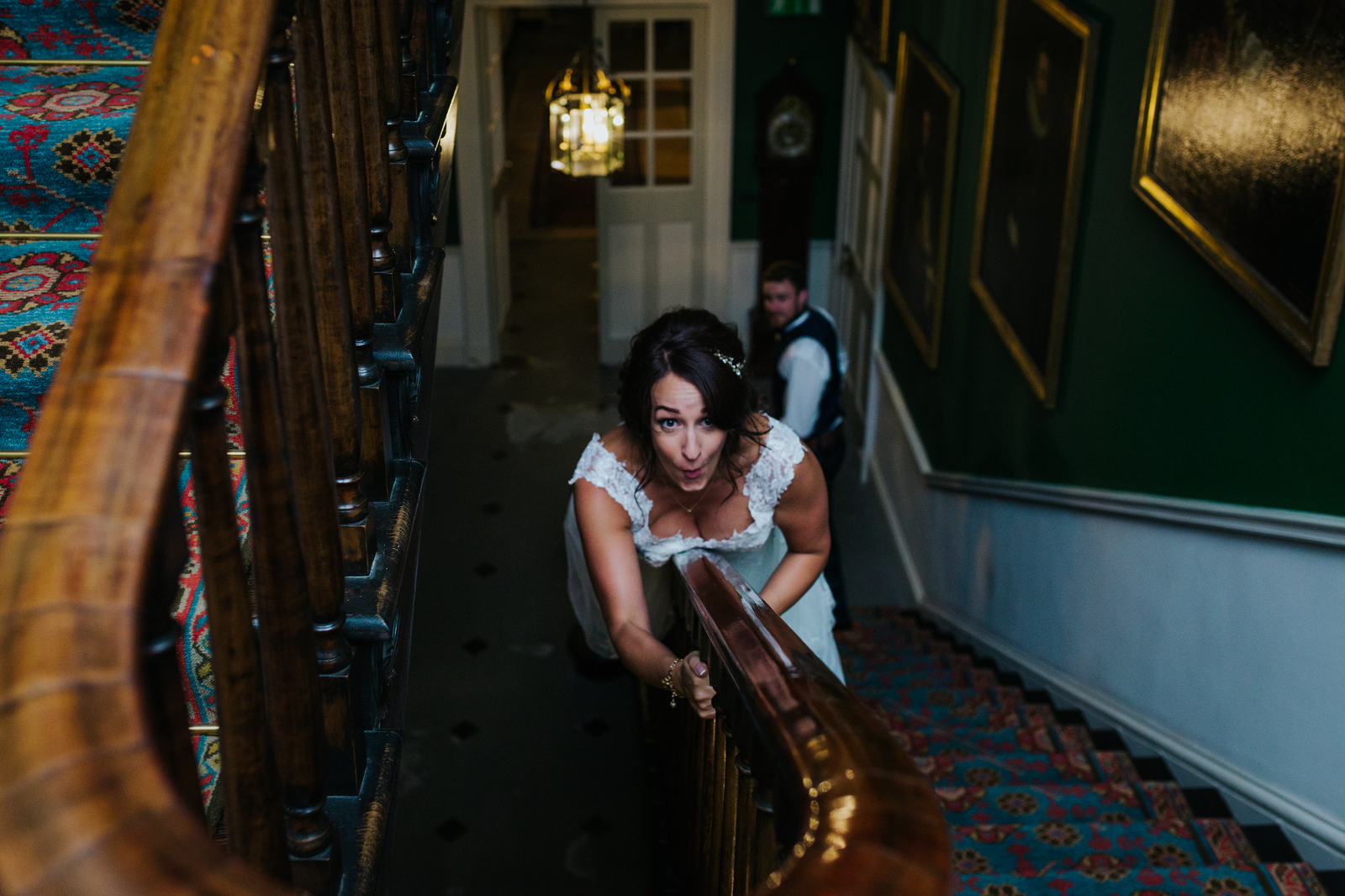 bride-sliding-down-bannister-in-wedding-dress